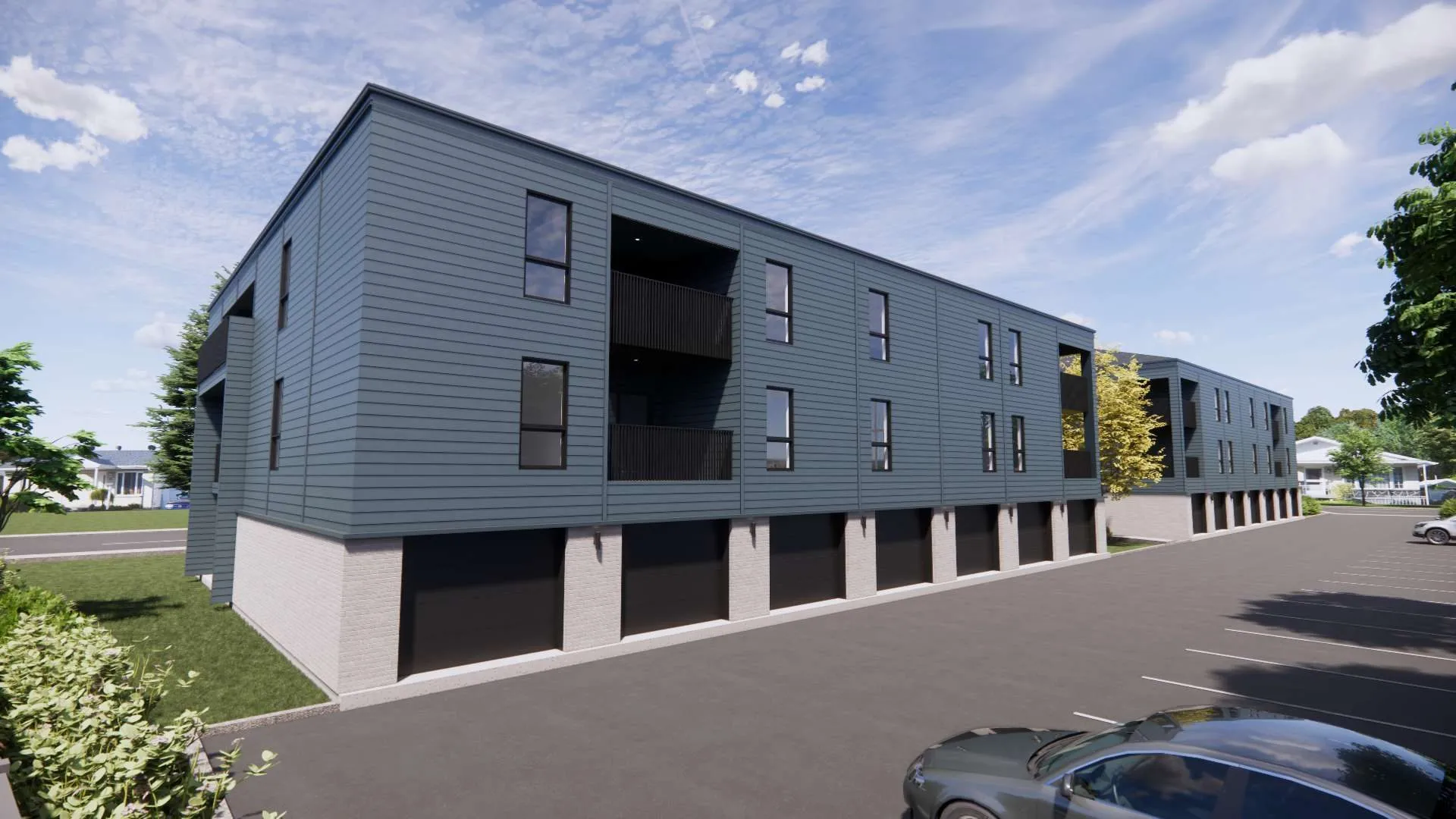 Rendu 3D des deux immeubles en perspective, garages alignés sous les logements